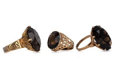 Lot 474 - THREE SMOKY QUARTZ DRESS RINGS