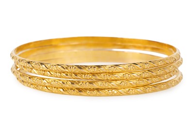 Lot 715 - FOUR GOLD BANGLES