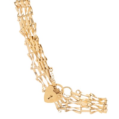 Lot 453 - GOLD BANGLE AND A GATE BRACELET