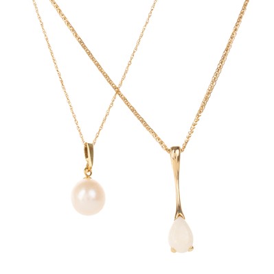 Lot 515 - TWO GOLD PENDANTS ON CHAINS