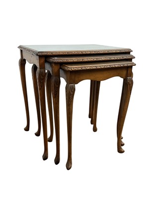 Lot 252 - MAHOGANY NEST OF THREE TABLES AND A FOOTSTOOL
